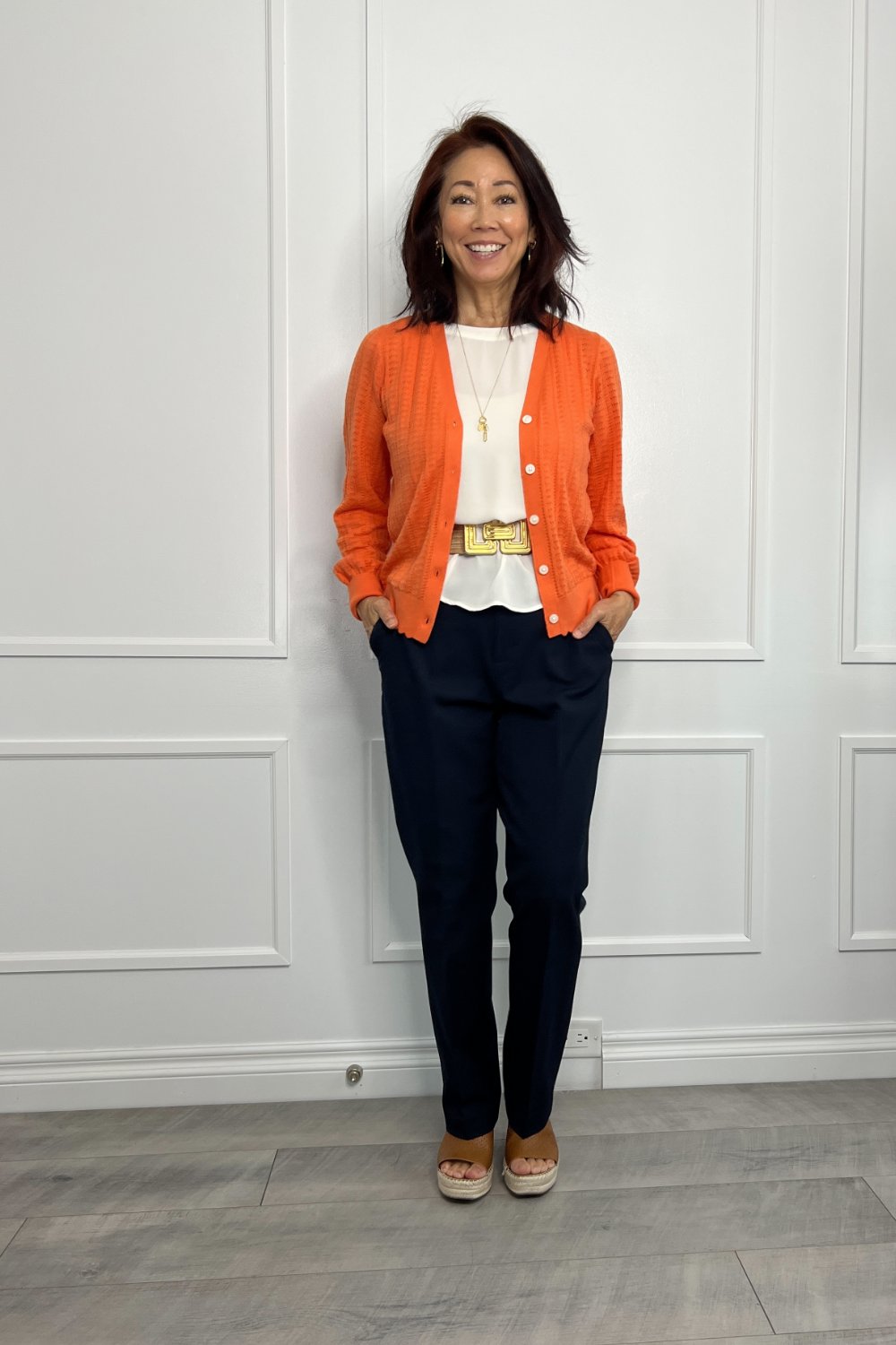 orange scalloped cardigan and brown espadrille